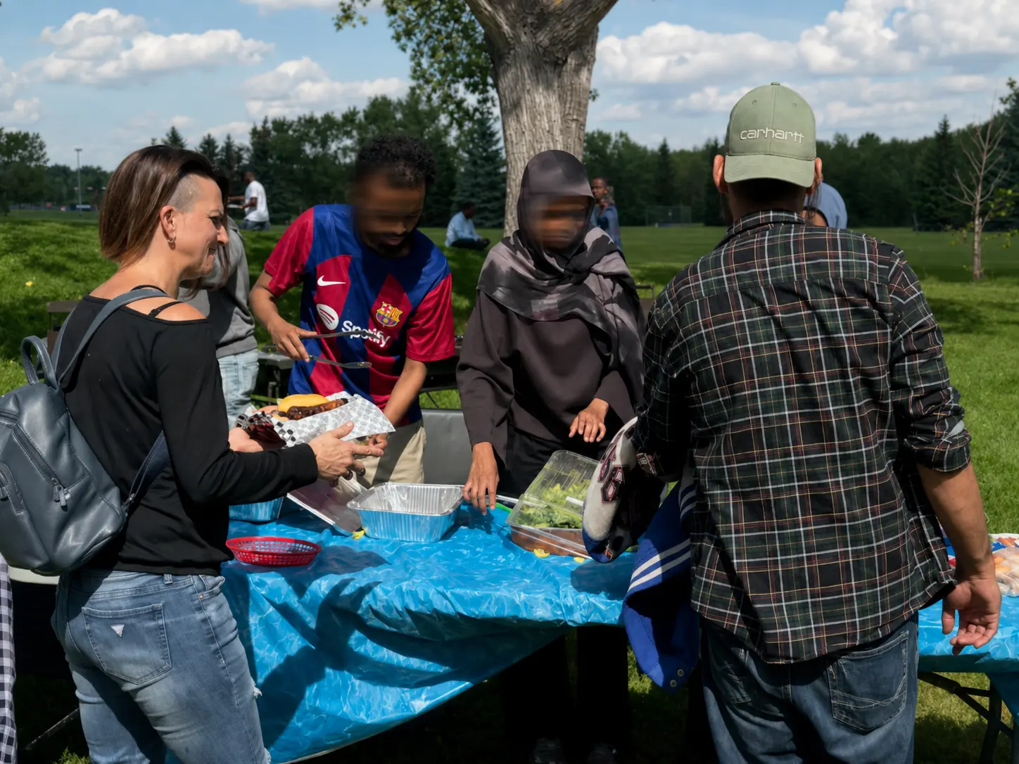GDS volunteers serving food at a community event, with requested faces privacy blurred